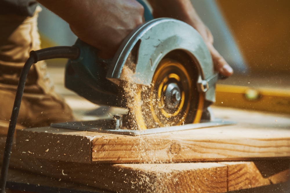 Carpenter using a large circular saw to cut wood