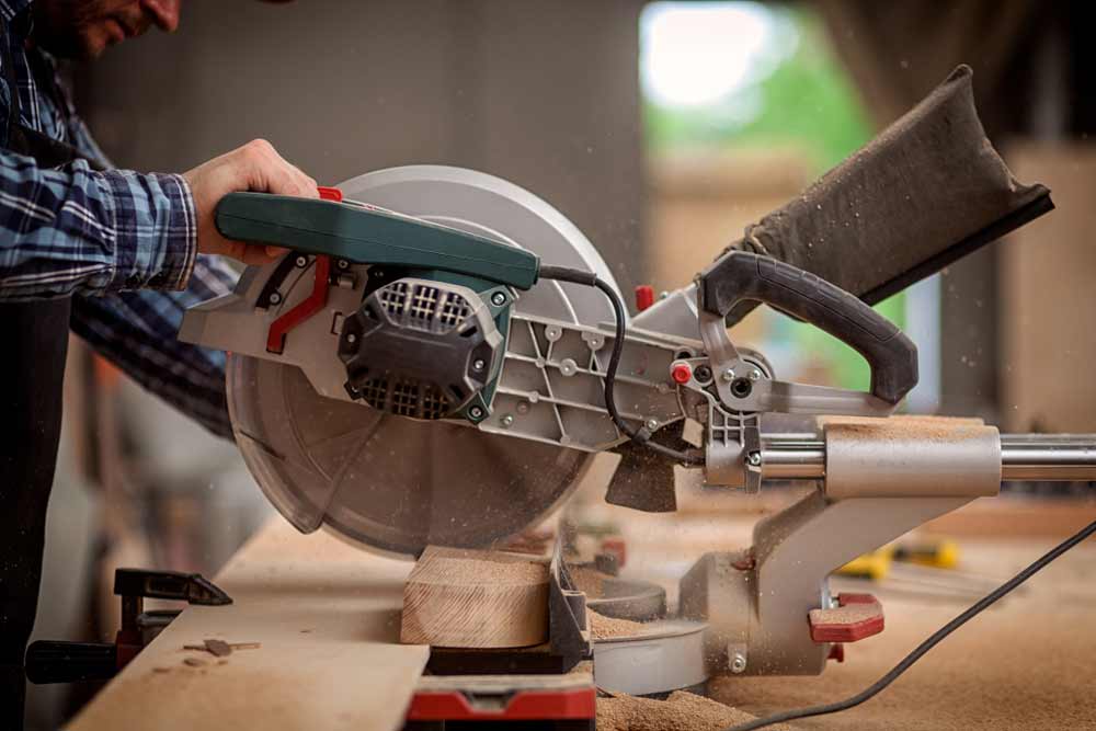 Carpenter Working With Circular Saw Cutting A Wood